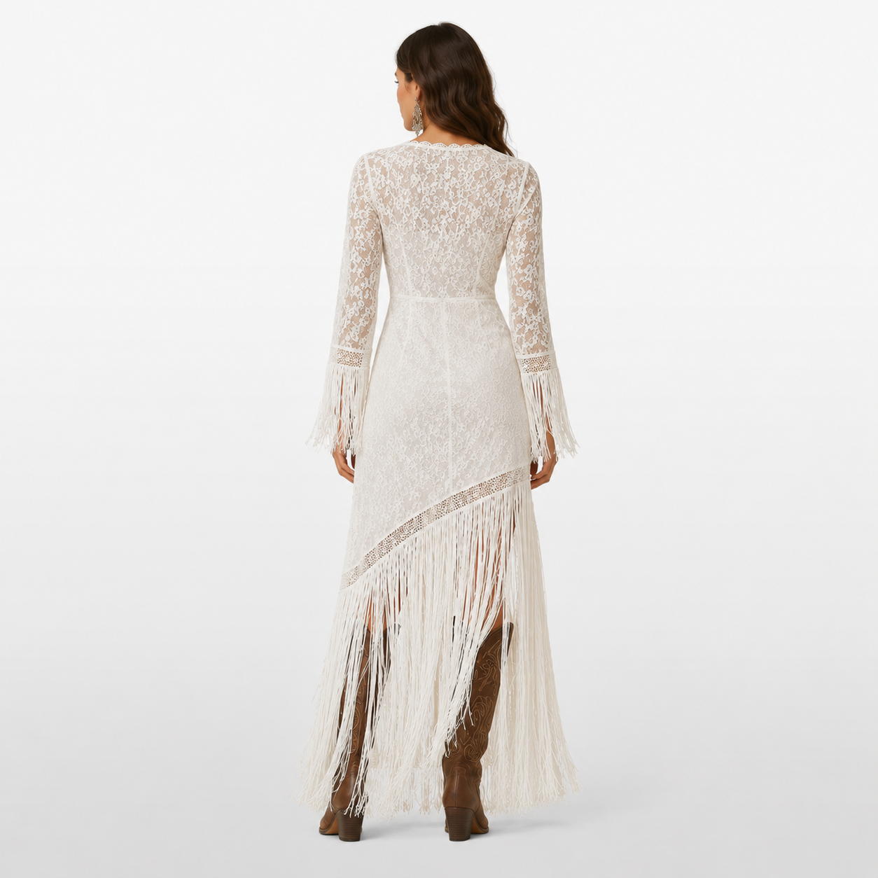 Woman wearing a long, white lace dress with fringe details on a white background