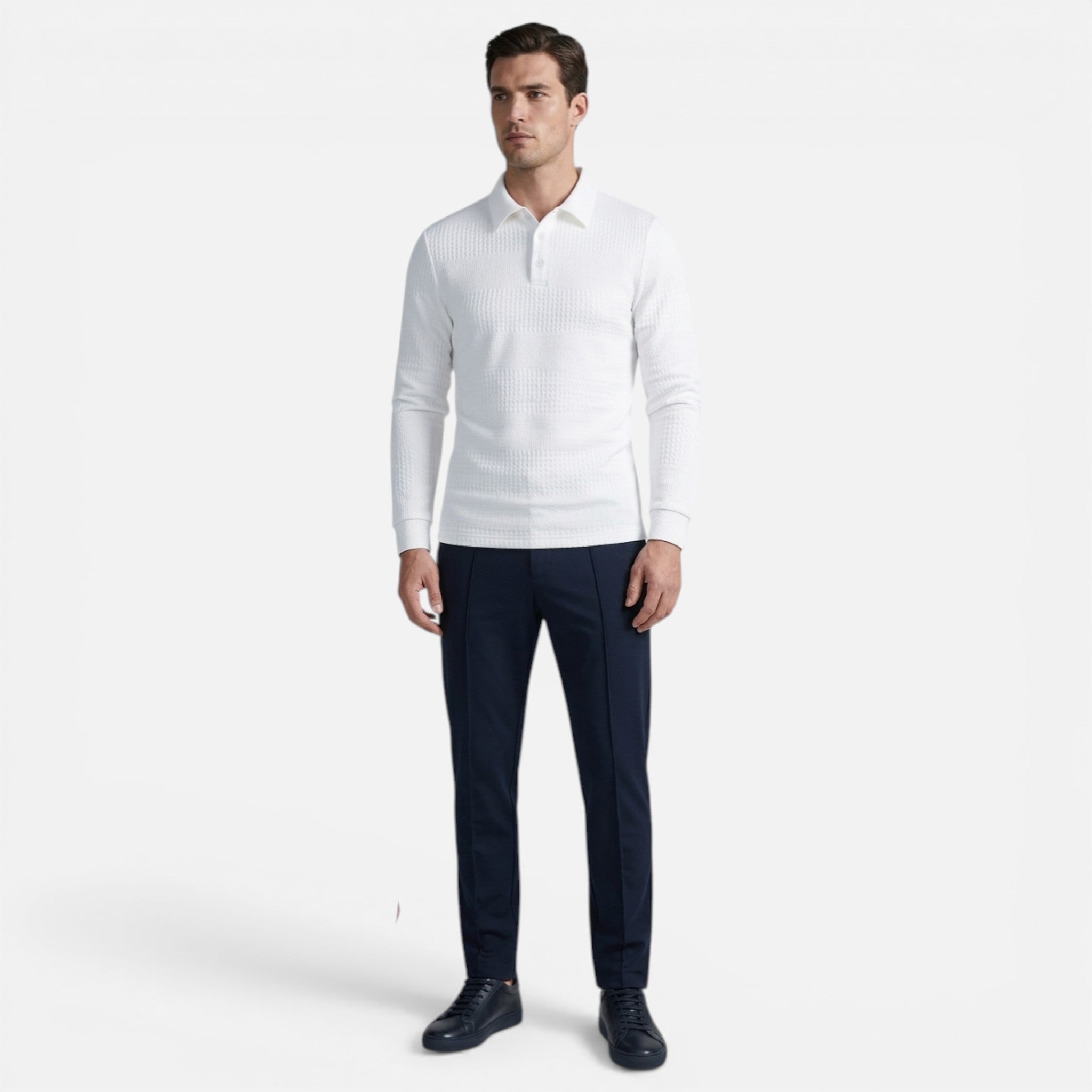 Man wearing a white long-sleeve shirt and dark pants on a white background