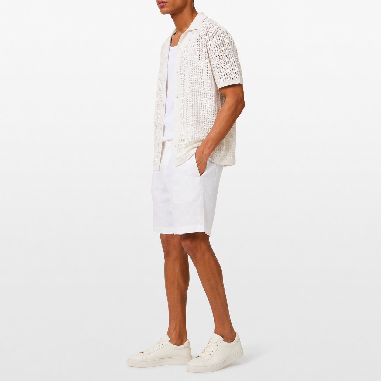 Person wearing a white outfit with a plain background