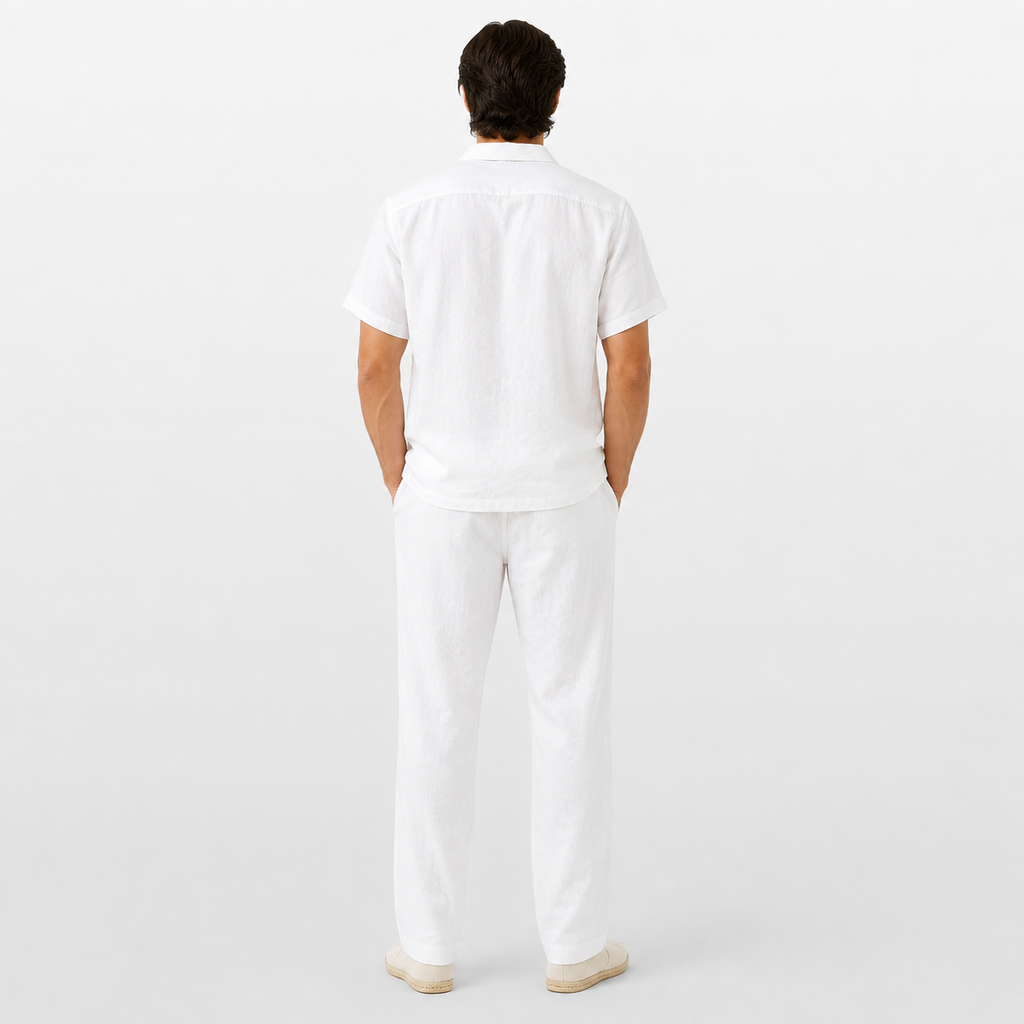 Person wearing a white outfit on a plain background