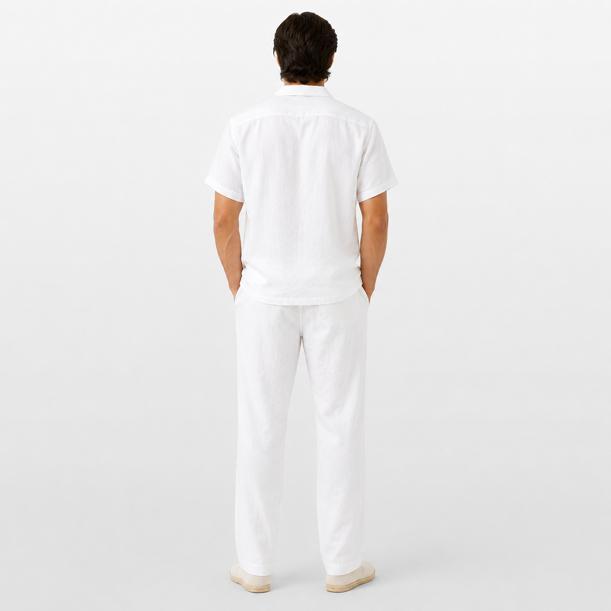 Person wearing a white outfit on a plain background