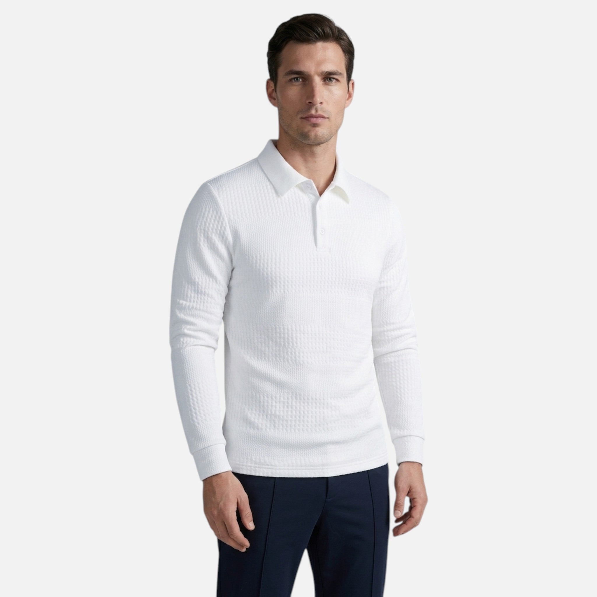 Man wearing a white ribbed sweater and dark pants on a light gray background