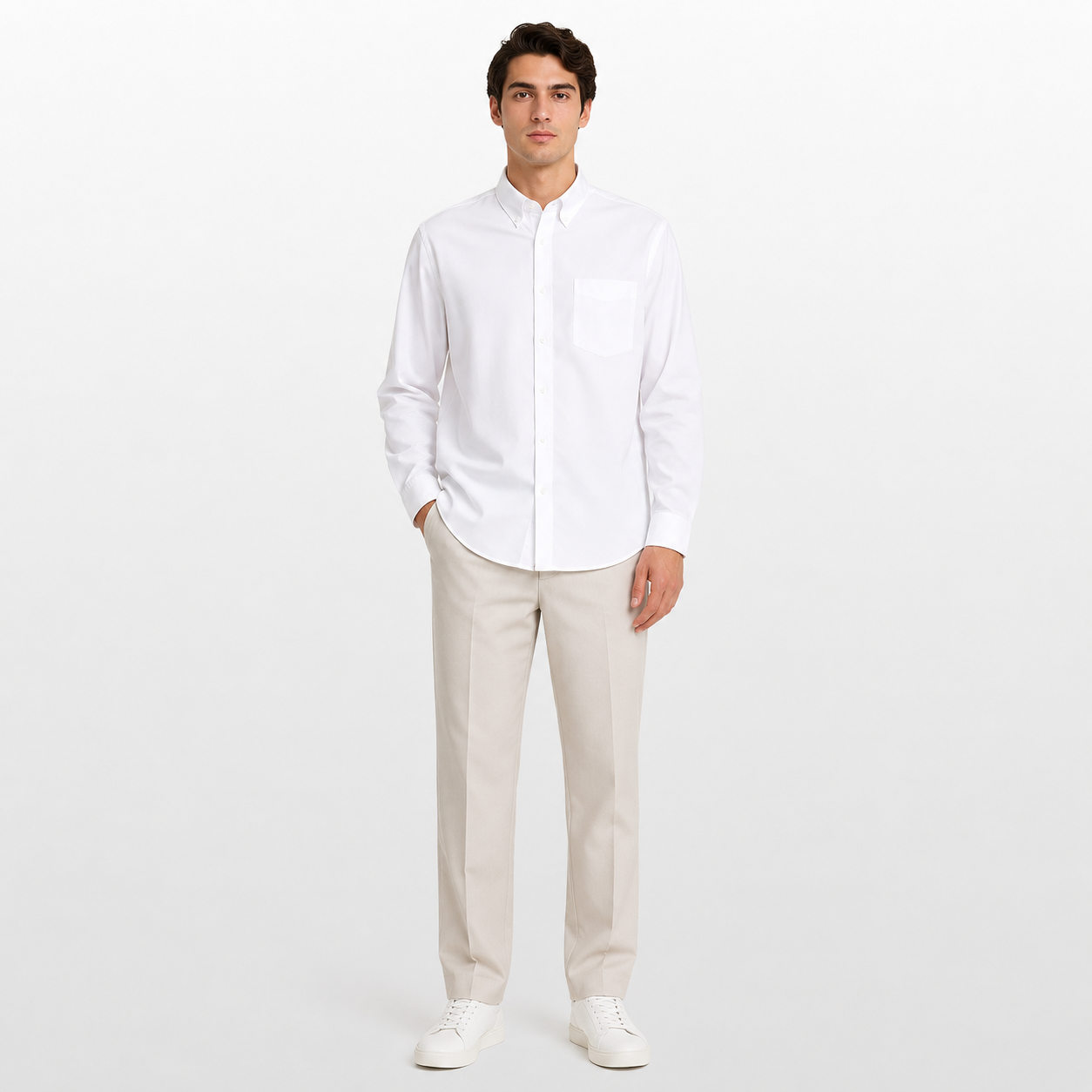 Man wearing a white shirt and beige pants on a white background