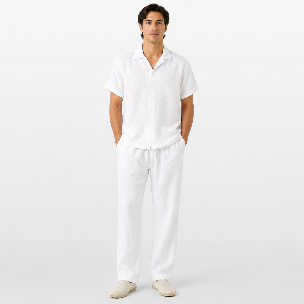 Man wearing a white shirt and pants on a light gray background