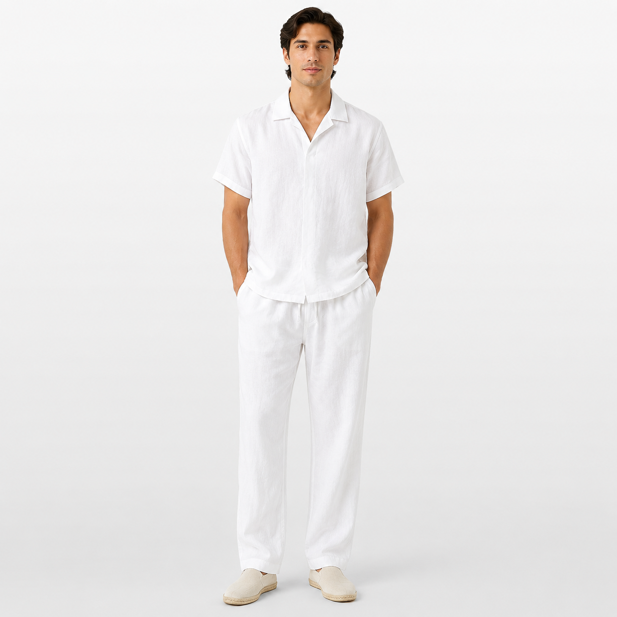 Man wearing a white shirt and pants on a light gray background