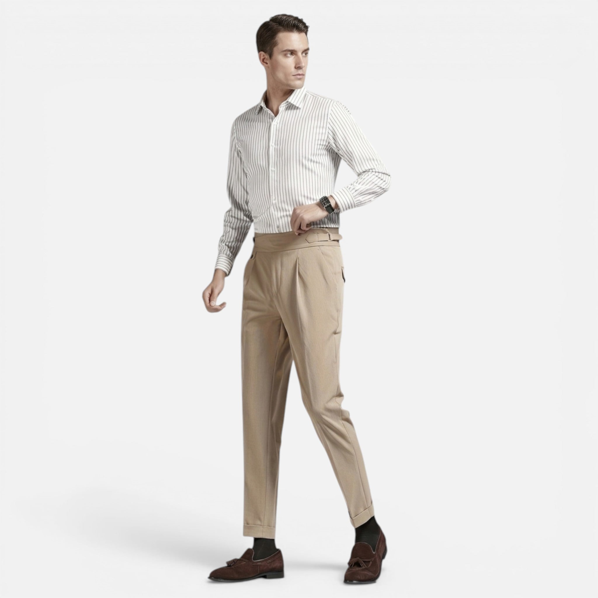 Man wearing a white shirt with black stripes and beige pants on a light gray background