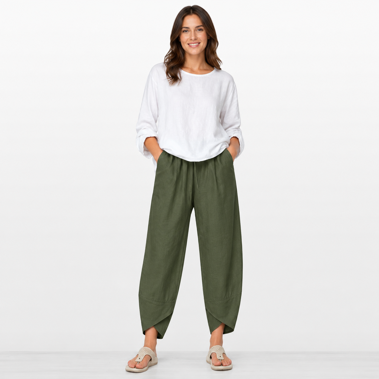 Woman wearing a white top and green pants on a white background