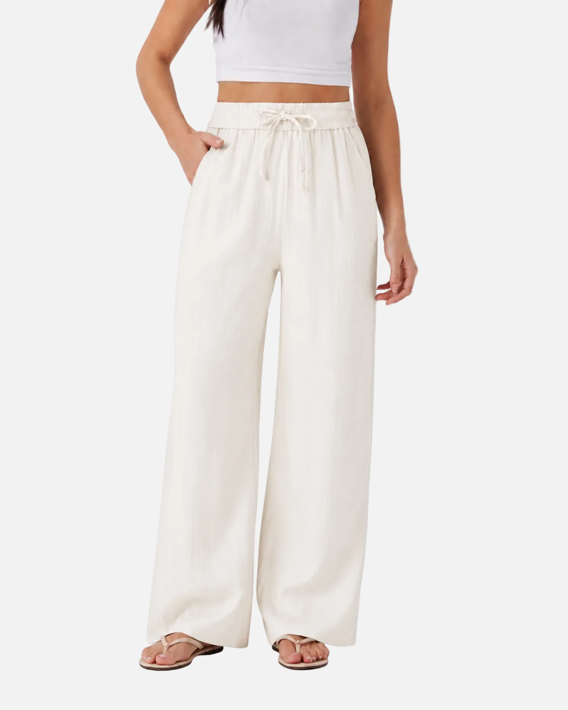Person wearing white wide-leg pants on a plain background