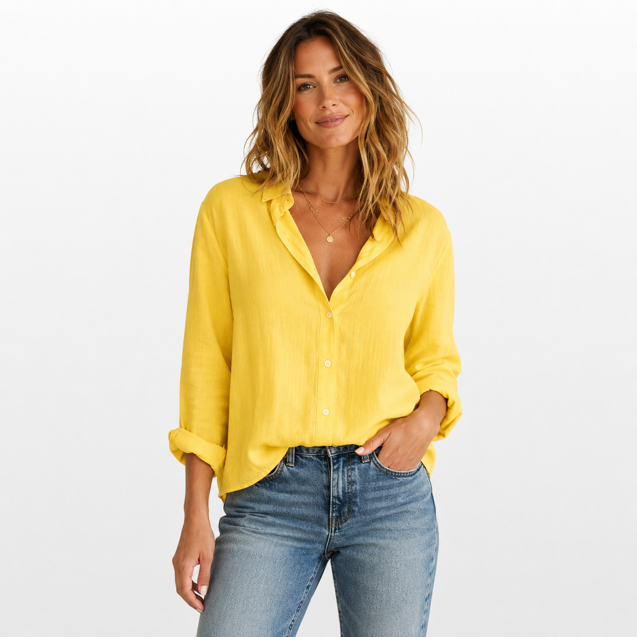 Woman wearing a yellow blouse and blue jeans on a white background