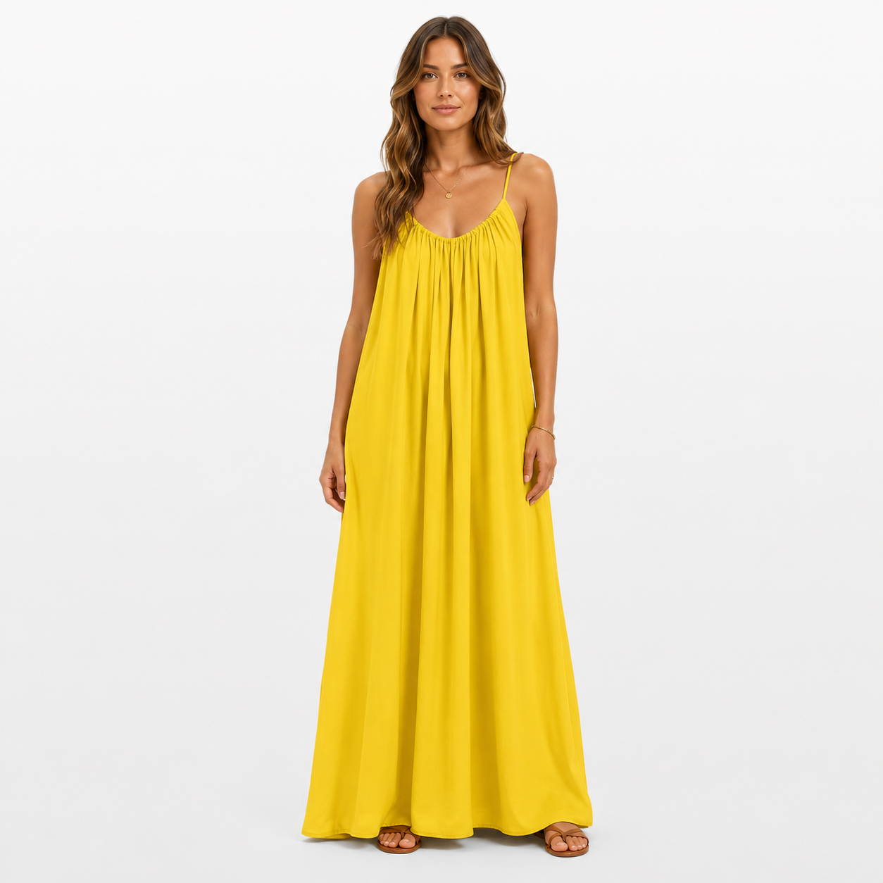 Woman wearing a yellow maxi dress on a white background