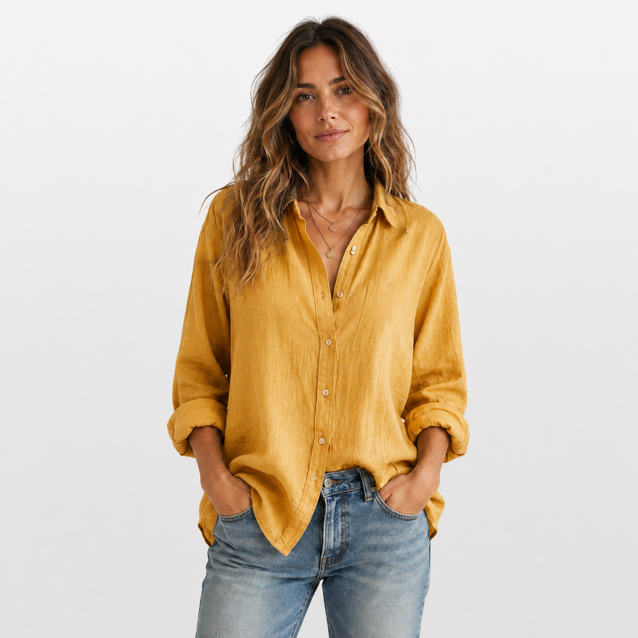 Woman wearing a mustard yellow shirt and blue jeans on a white background