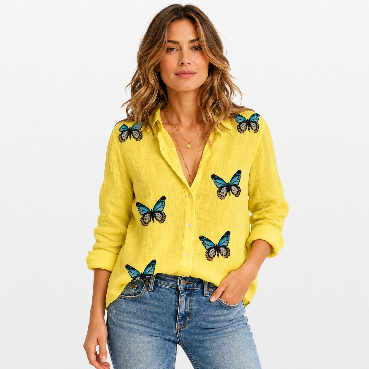 Woman wearing a yellow shirt with butterfly designs on a white background
